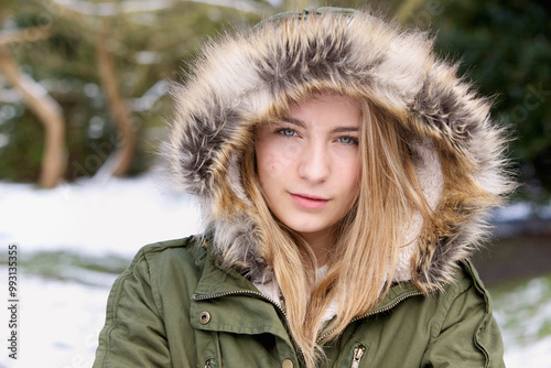 Teenage Girl Wearing Hooded Parka Outdoors
 photo