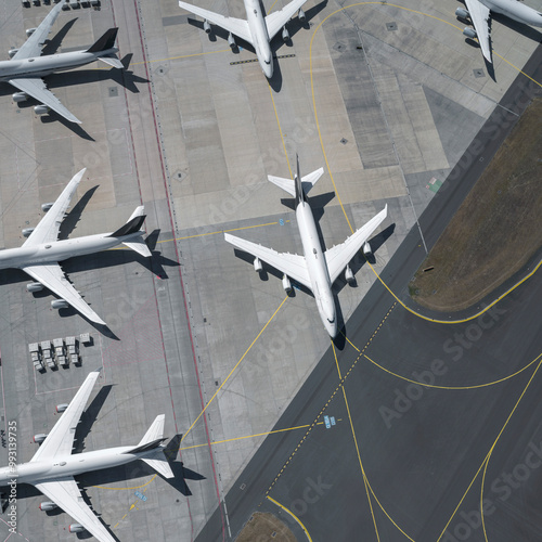 View from above airplanes on sunny airport tarmac and runway
