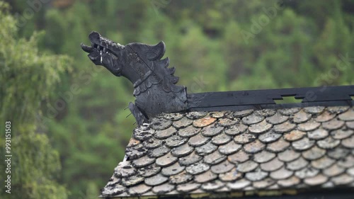 A carved wooden dragon head decoration on the traditional tiled roof of the Elveseter Hotel, Norway photo