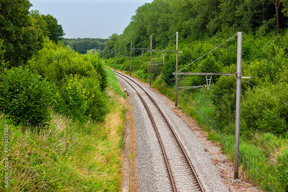 Railway line south of the town of Ypres, Ieper, Belgium. Country railway line. Railway line south of the town of Ypres, Ieper, Belgium. Country railway line.