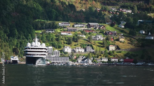 Wallpaper Mural A large cruise ship departs the port near the village in Geiranger Fjord, with houses and green hills in the background. Torontodigital.ca