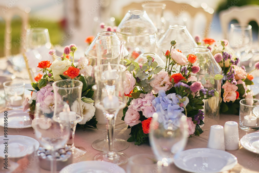 Elegant Waterfront Outdoor Wedding Reception with Draped Canopy, Floral Centerpieces, and White Chairs at a Luxurious Seaside Venue Elegant Waterfront Outdoor Wedding Reception with Draped Canopy, Floral Centerpieces, and White Chairs at a Luxurious Seaside Venue