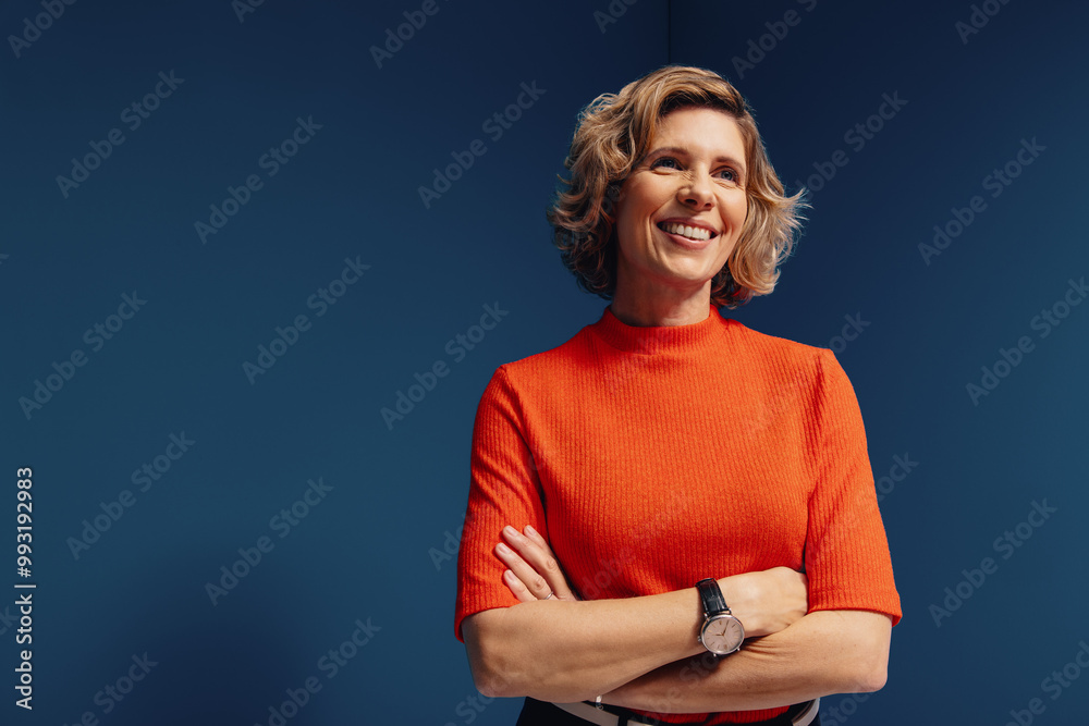 © Jacob Lund - Confident mature businesswoman in vibrant colorblocking portrait with a blue and orange monochromatic set