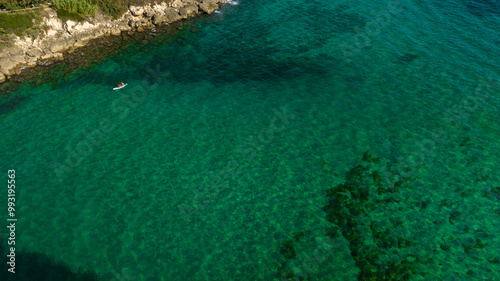 Aerial view of a couple surfing on a sup in the Mediterranean Sea.