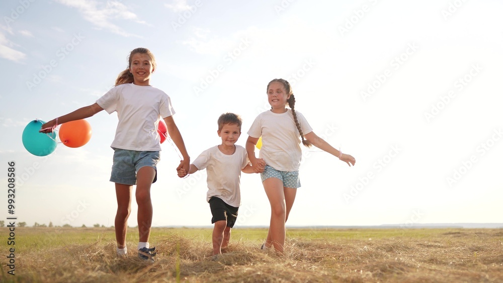 Children running in nature with balloons. Happy family kid dream concept. Group of kids playing with balloons in park. Children playing in the park with balloons and running through nature lifestyle. Children running in nature with balloons. Happy family kid dream concept. Group of kids playing with balloons in park. Children playing in the park with balloons and running through nature lifestyle.