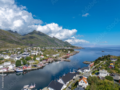 Village image of Sorvagen in middle of lush landscape, with view of Vestfjord in background. Lofoten district in Norway