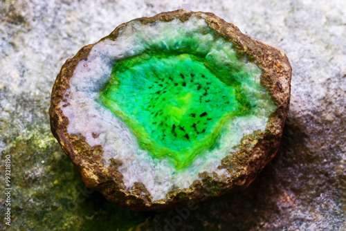 Radioactive mineral glowing in darkness, unique texture, scientific discovery photograph. photo