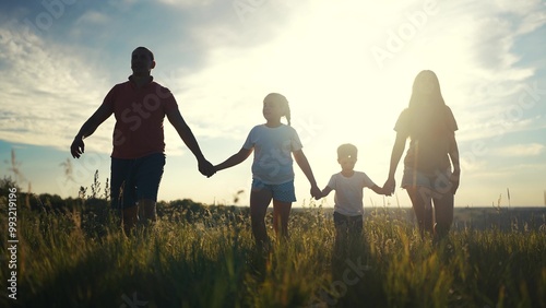 Silhouette of a family walking in nature. Happy people child concept. Family with children walking in the park. Silhouette of a family walking in nature in lifestyle the park.