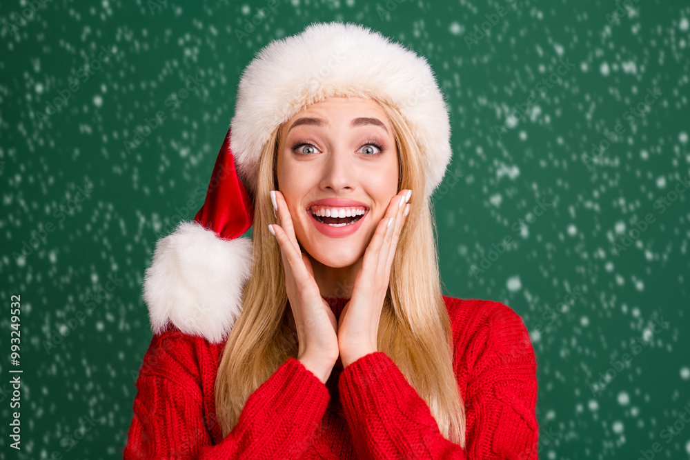 Photo of cheerful young positive happy woman hold hands face cheeks xmas isolated on green color background