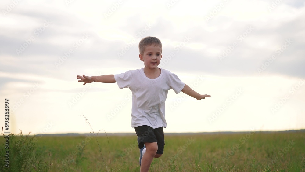 Boy and son running in nature. Father dad smile concept. A kid runs on the grass in a park. A boy and his son run through lifestyle the grass in a park. Boy and son running in nature. Father dad smile concept. A kid runs on the grass in a park. A boy and his son run through lifestyle the grass in a park.