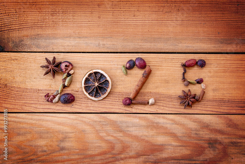 Quadro em tela 2025 written with Christmas spices and dried fruits on wooden background, new ye