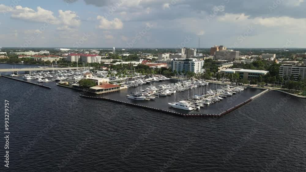 Aerial view of Bradenton marina with boats docked and the city skyline over the Manatee River. Crane Up Right Day Aerial view of Bradenton marina with boats docked and the city skyline over the Manatee River. Crane Up Right Day