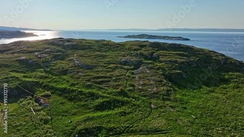 Aerial view of a child and man climbing on top of a hill, summer in north Norway photo