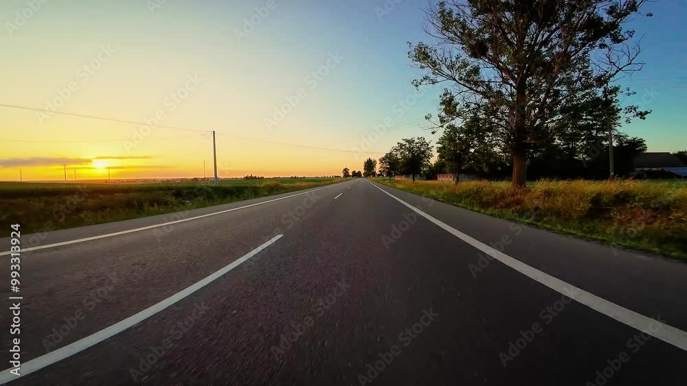 Driving along rural asphalt road at sunset. Windshield revealing new POV horizons, Travel, relaxation, active leisure, exploration Driving along rural asphalt road at sunset. Windshield revealing new POV horizons, Travel, relaxation, active leisure, exploration
