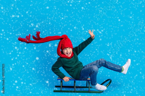 Fototapeta Full length body size photo boy shouting riding sledges isolated bright blue col