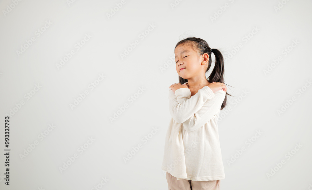 Happy young child smiling Asian girl hugging herself remember a moment studio short isolated on white background, Self care and self esteem concept, Lifestyle kindergarten kid love yourself carefree Happy young child smiling Asian girl hugging herself remember a moment studio short isolated on white background, Self care and self esteem concept, Lifestyle kindergarten kid love yourself carefree