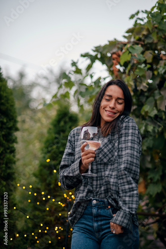 attractive brunette drinking wine by autumn evening