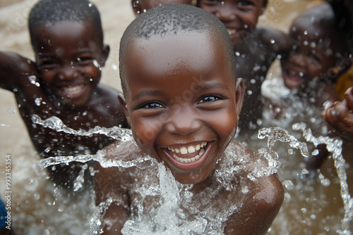 African Children having fun with water from a recently installed water well.