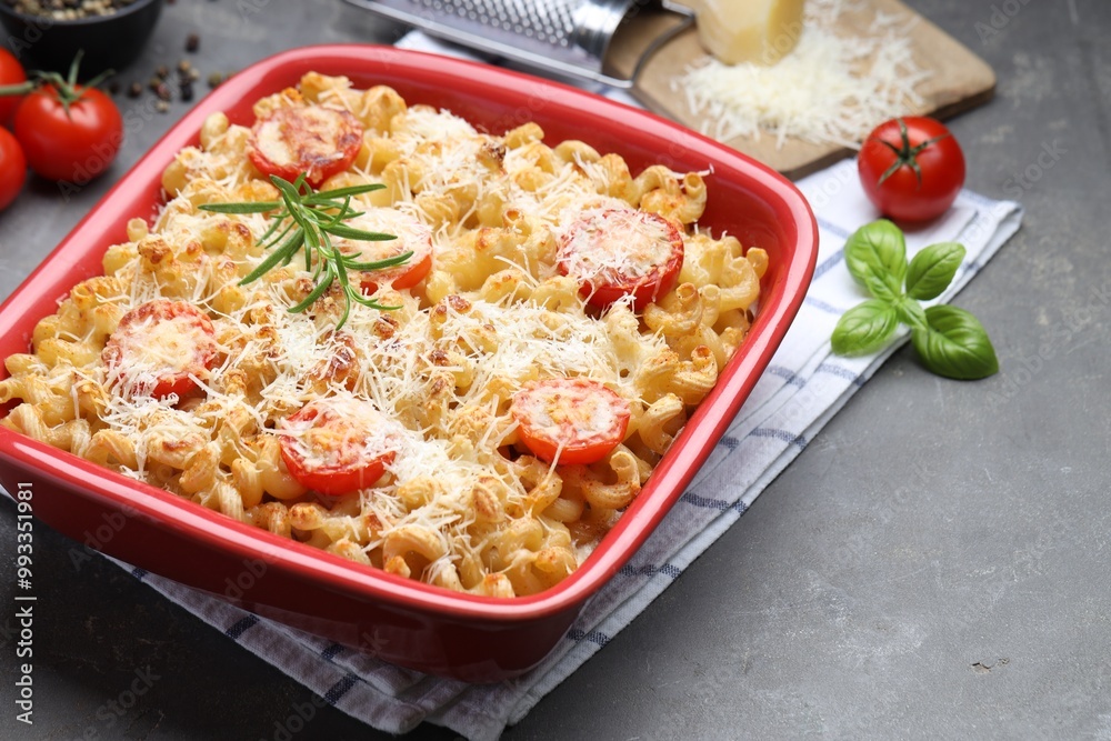 Delicious al forno pasta in baking dish on grey table, closeup Delicious al forno pasta in baking dish on grey table, closeup