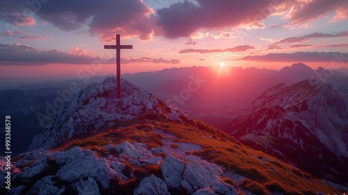 Celtic cross on mountain peak at sunset