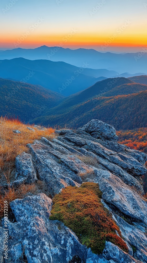 Fototapeta premium Panoramic view of mountain range during autumn sunrise