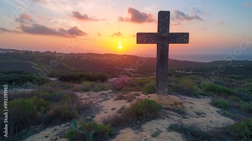 Celtic cross on mountain peak at sunset