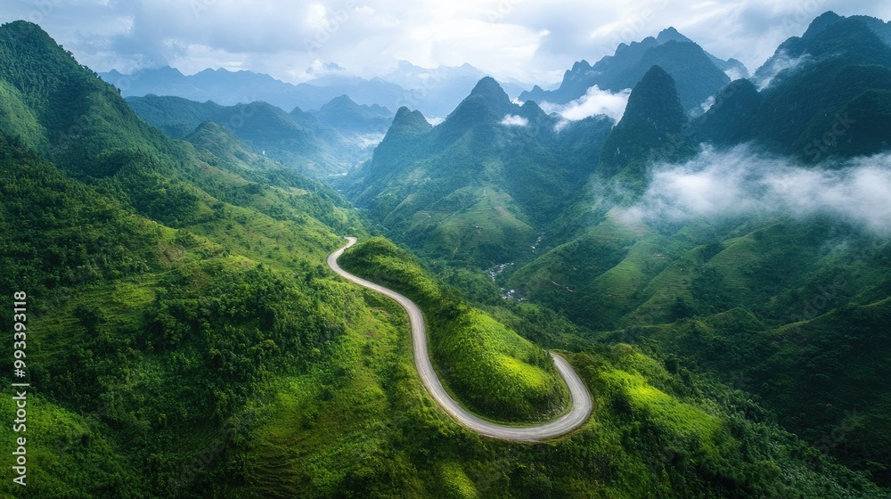 A winding mountain road cutting through lush green hills, with towering peaks in the distance and clouds drifting over the landscape. A winding mountain road cutting through lush green hills, with towering peaks in the distance and clouds drifting over the landscape.