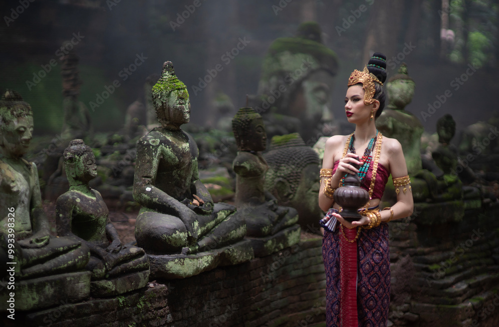 Beautiful young ASEAN woman in traditional Thai Dvaravati dress in an old temple in Chiang Mai, Thailand. Beautiful young ASEAN woman in traditional Thai Dvaravati dress in an old temple in Chiang Mai, Thailand.