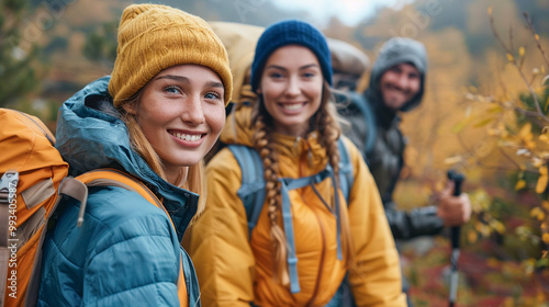 Friends hiking in the mountains with fall foliage in the blurred background, active lifestyle.