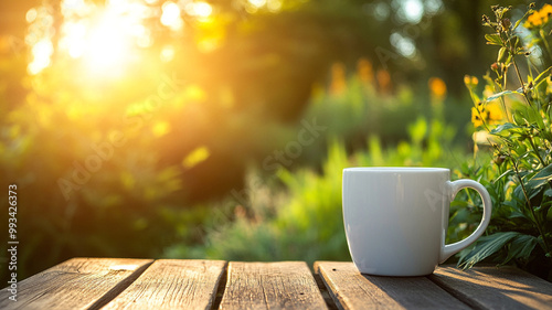 A white coffee cup on a wooden table in a garden at sunrise