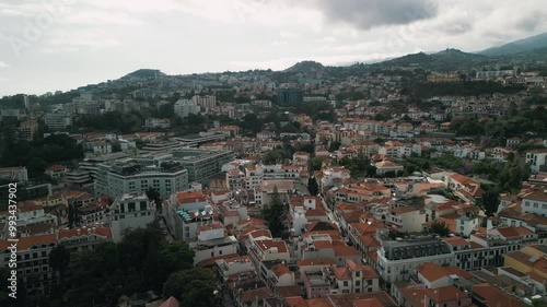 Funchal cityscape, the capital of Madeira island, Portugal. City panorama with the mountains in background. Drone aerial video