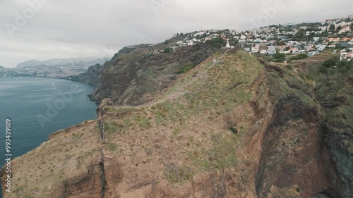 Peninsula with Christo Rei (Christ's Monument) on the Madeira Island near Canico, Portugal. Panorama of the bay. Aerial drone video.
