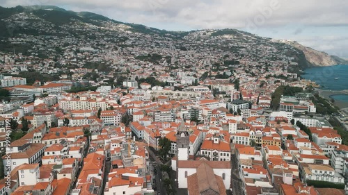 Funchal city aerial drone video with the Cathedral of Our Lady of the Assumption, Old Town of Funchal, Madeira Island, Portugal. Aerial drone view.