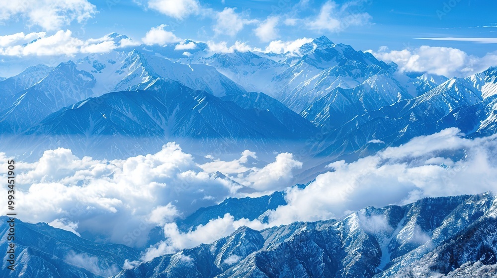 Obraz premium Majestic Snow Mountain with Billowing Clouds: A Breathtaking Natural Spectacle. Witness the Grandeur and Serenity.