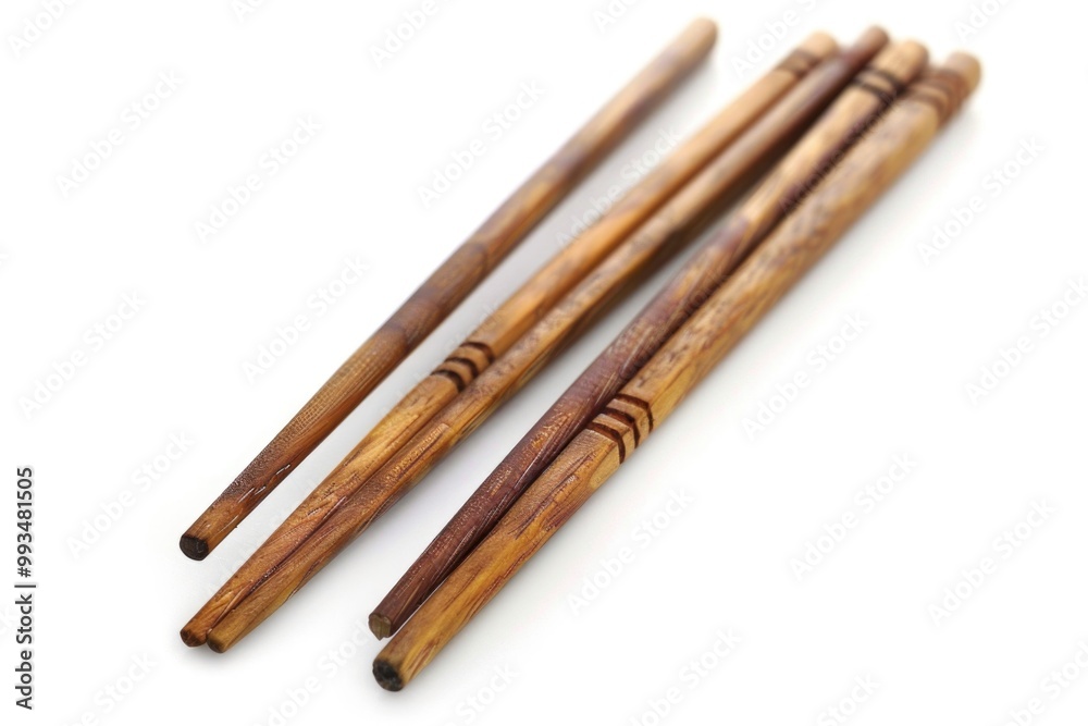 A group of chopsticks sitting next to each other, Asian-inspired utensils A group of chopsticks sitting next to each other, Asian-inspired utensils