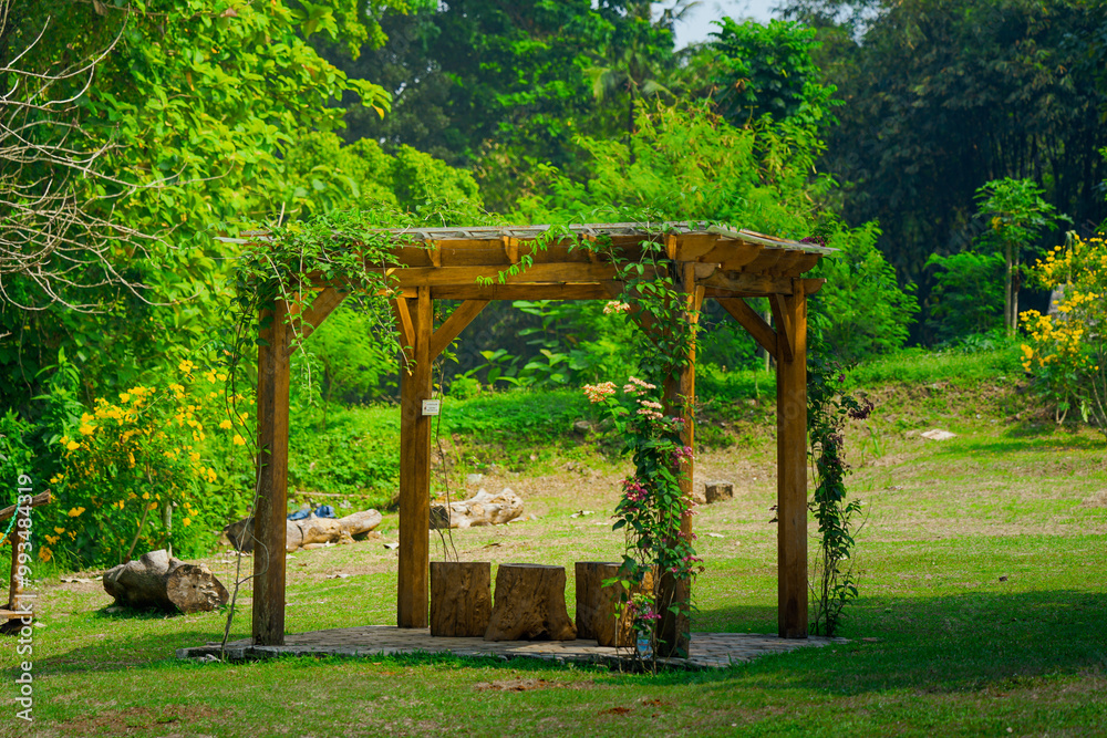 Jakarta, 26 September 2024: Outdoor seating area. Gazebos, pergolas in the garden and garden - relax and unwind. Wooden gazebo in the garden. Jakarta, 26 September 2024: Outdoor seating area. Gazebos, pergolas in the garden and garden - relax and unwind. Wooden gazebo in the garden.