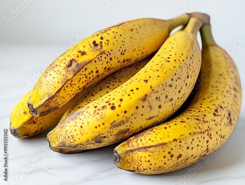 A perfectly ripe bunch of bananas sitting gracefully on a clean white background, showcasing their vibrant yellow color and smooth texture, inviting you to enjoy their sweet, natural flavor and wholes