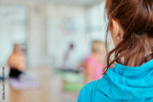 A blurred image of a group of senior women practicing yoga to maintain a healthy and active aging process. photo