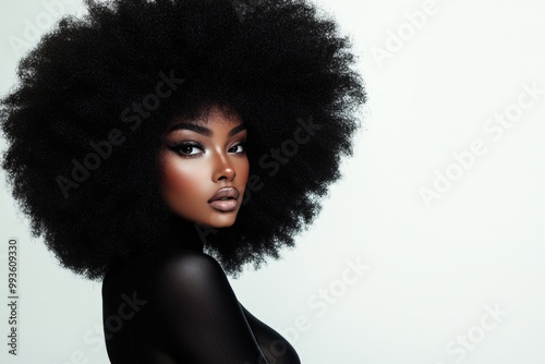 A beautiful Black woman with a large, voluminous afro hairstyle, posing for the camera.