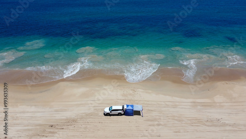 Four wheel drive, 4WD, 4×4, four by four, beach driving, day trip from Perth and camping on the beach.  Summer, Western Australia. Turquoise colored water, and white sand. Drone point of view photo