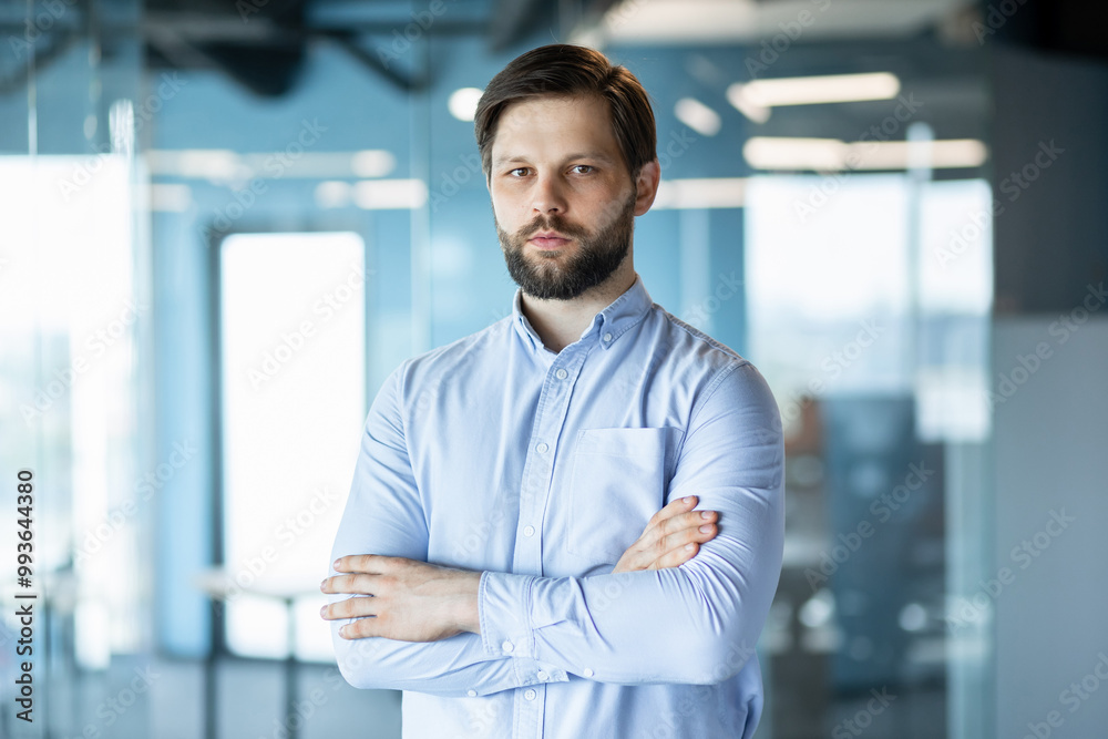 Confident Businessman Standing in Modern Office Environment