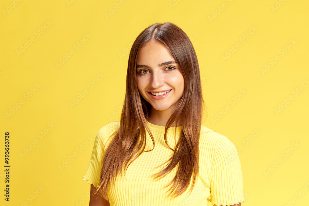 Young beautiful girl, student looking with bright smile at camera against bright yellow background. Positive people. Concept of human emotions, business, beauty and fashion, sales season. Ad Young beautiful girl, student looking with bright smile at camera against bright yellow background. Positive people. Concept of human emotions, business, beauty and fashion, sales season. Ad