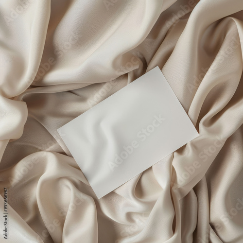 A5 white card mockup on top of beige fabric, in the style of soft light, minimalistic aesthetic template