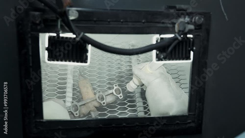 Sandblasting metal parts in a factory, sandblasting. Industrial worker sprays with a pressure sand gun