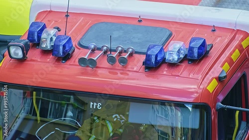 Close-up of a blue flashing light of a siren on a red car of firefighters, ambulance or rescuers.