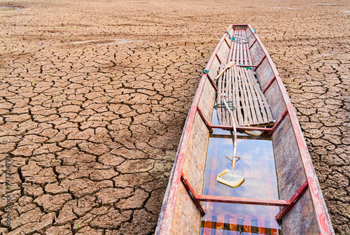 Wallpaper Mural The ground is cracked and parched, with a network of deep fissures. Several traditional wooden boats are beached on the dried-up water body, highlighting the severity of the drought. Torontodigital.ca