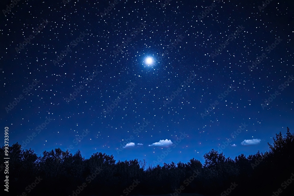 Fototapeta premium Night sky filled with twinkling stars and a deep, dark blue hue, with the moon shining brightly