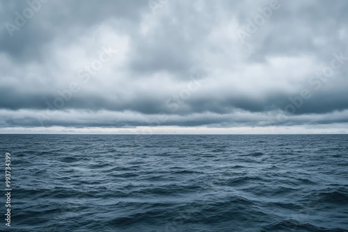 Overcast sky with thick, grey clouds covering the entire horizon, creating a moody and calm atmosphere