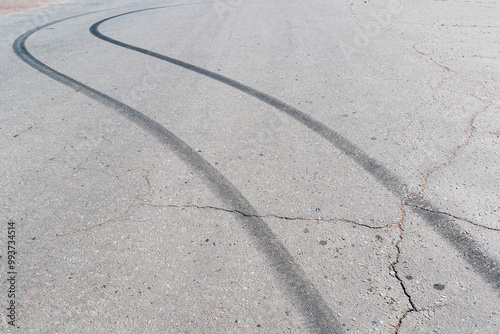 Black traces of car braking on the asphalt. Close-up of skid marks on the road.