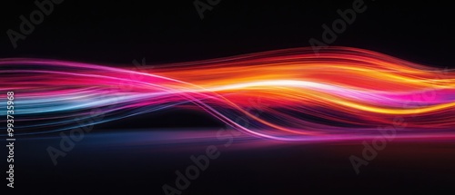 Abstract flowing waves of vibrant colors on a dark background.